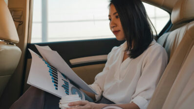 woman reading report in a car