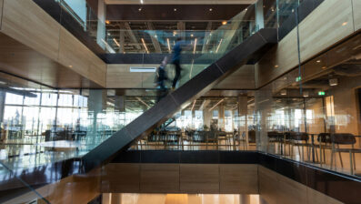 people walking up stairs in a building